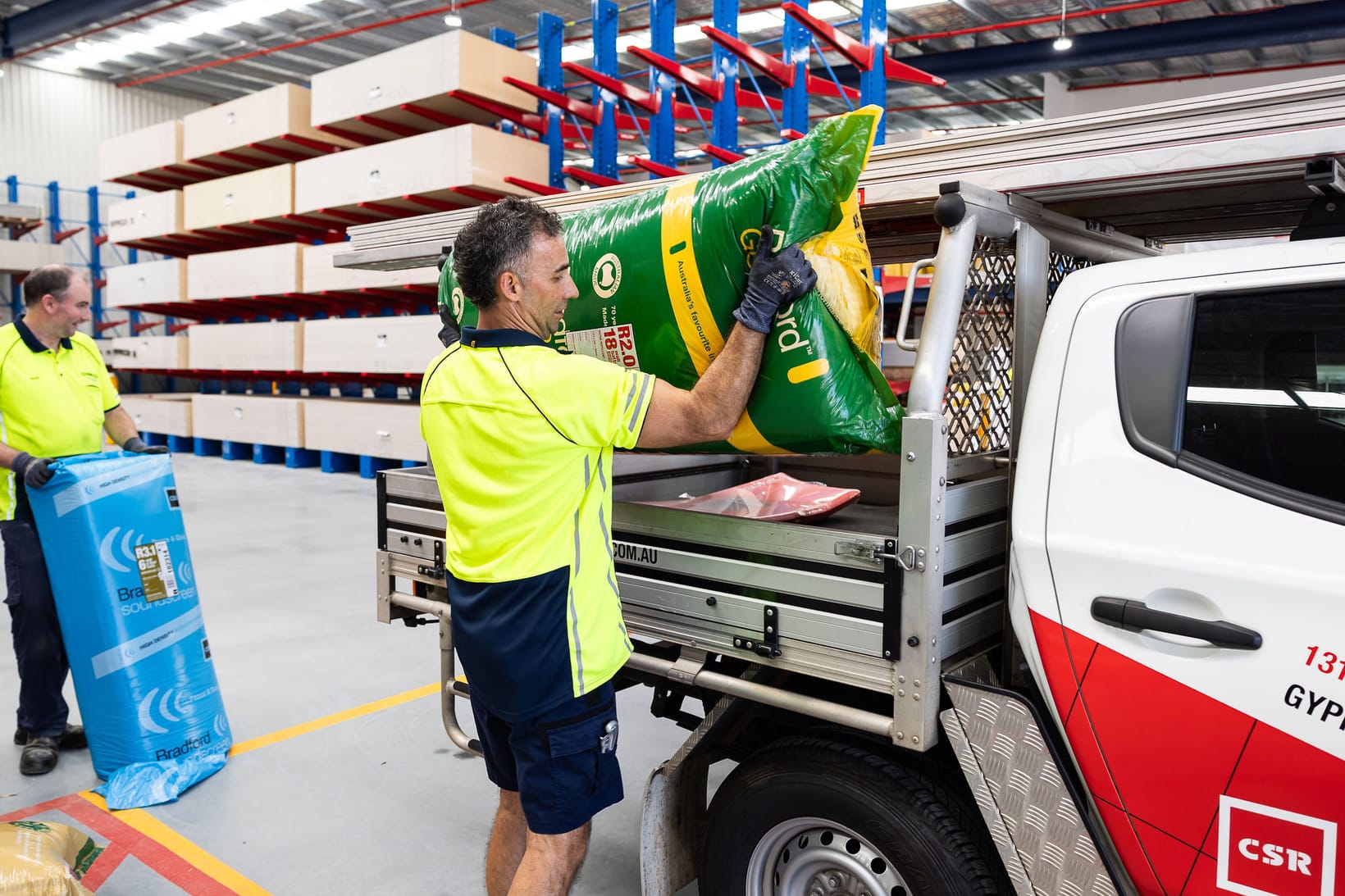 Man loading Bradford Insulation onto truck